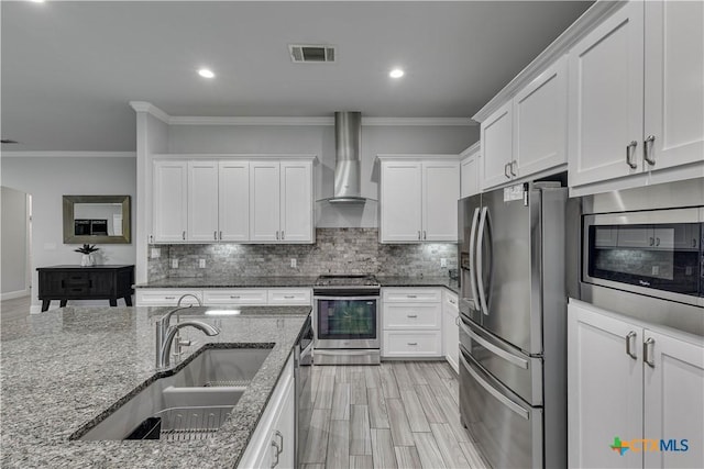 3935 Outpost Trce, Lago Vista, TX 78645 - kitchen with appliances with stainless steel finishes, wall chimney exhaust hood, ornamental molding, recessed lighting, and tasteful backsplash