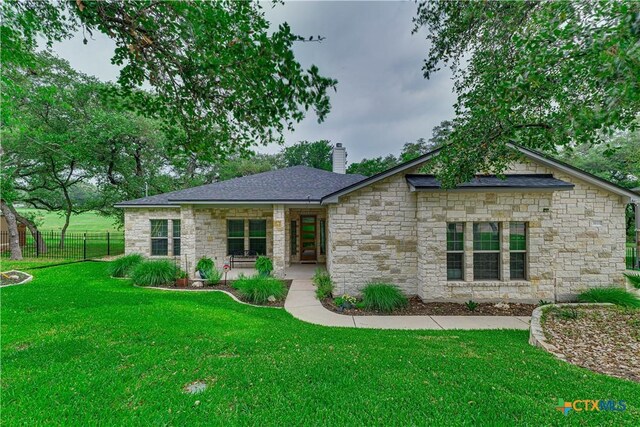 3935 Outpost Trce, Lago Vista, TX 78645 - view of front of home featuring stone siding and a chimney
