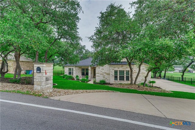3935 Outpost Trce, Lago Vista, TX 78645 - view of front facade with stone siding and driveway