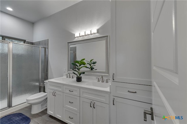 3935 Outpost Trce, Lago Vista, TX 78645 - bathroom with a stall shower, double vanity, and toilet