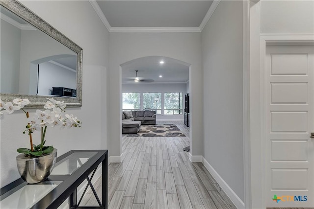 3935 Outpost Trce, Lago Vista, TX 78645 - hall featuring arched walkways, baseboards, ornamental molding, and light wood-type flooring