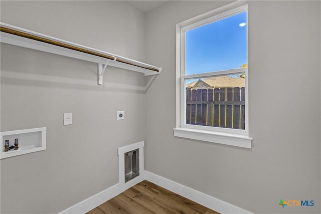 washroom with electric dryer hookup, hookup for a washing machine, and hardwood / wood-style floors