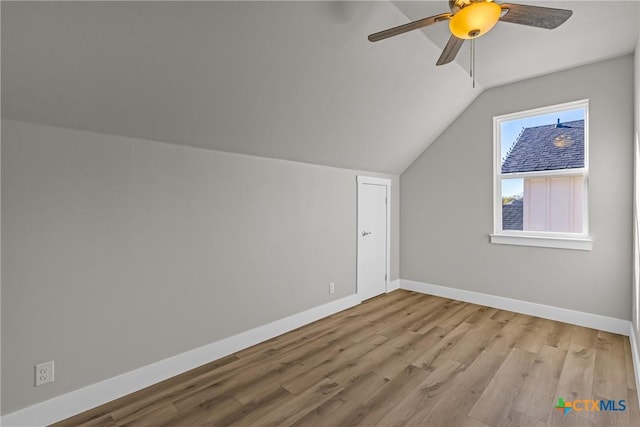 additional living space with ceiling fan, lofted ceiling, and light wood-type flooring