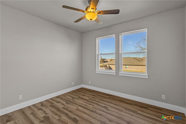 spare room featuring hardwood / wood-style floors and ceiling fan