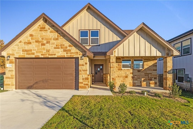 view of front of home with a front yard and a garage