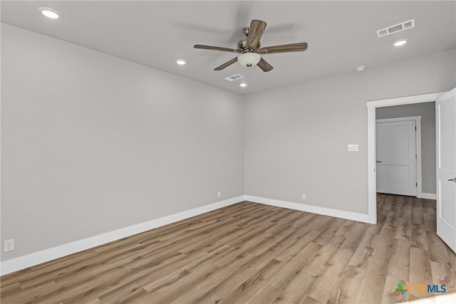 spare room featuring ceiling fan and light hardwood / wood-style flooring