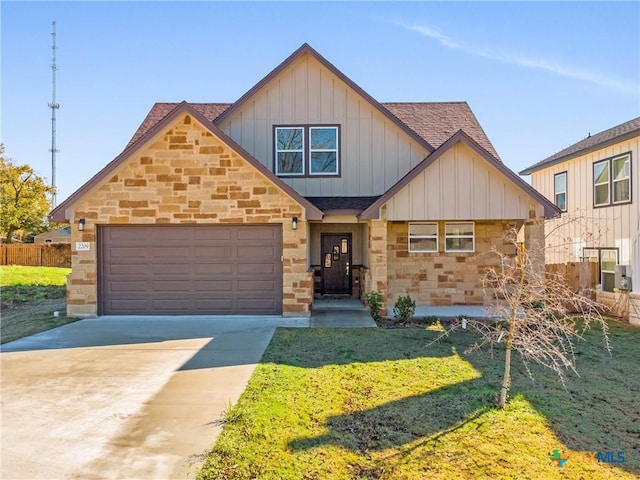 view of front of property featuring a front lawn and a garage