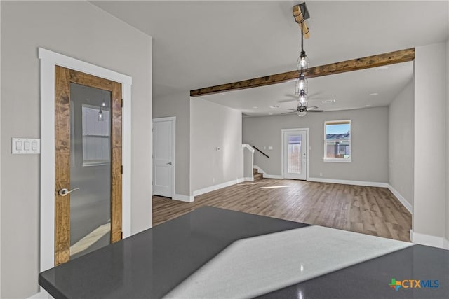 living room with beam ceiling, ceiling fan, and wood-type flooring