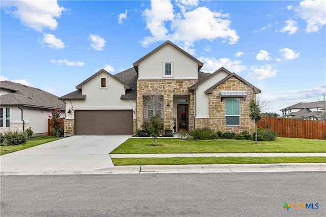 view of front of property featuring a garage and a front yard