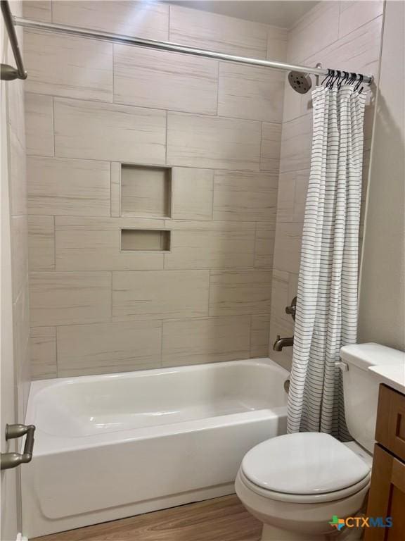 full bathroom with toilet, shower / bath combination with curtain, wood finished floors, and vanity