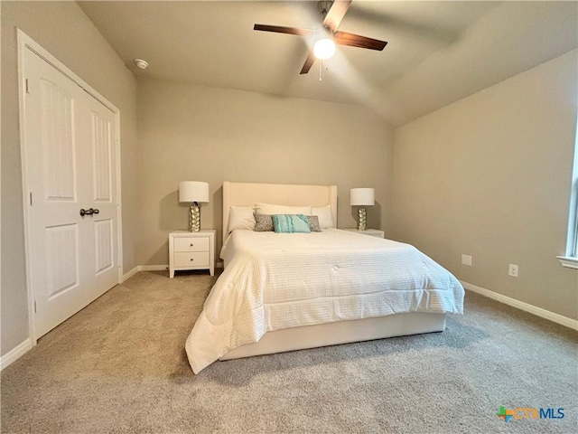 carpeted bedroom featuring vaulted ceiling, baseboards, and ceiling fan