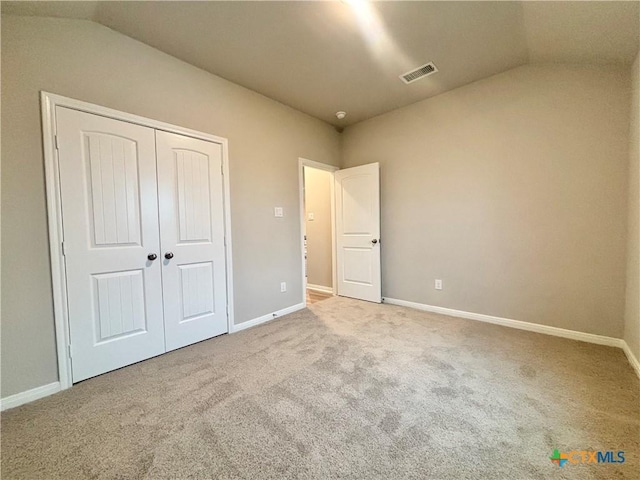 unfurnished bedroom with carpet flooring, visible vents, and baseboards