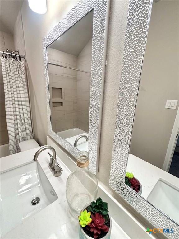 full bathroom featuring shower / tub combo and vanity