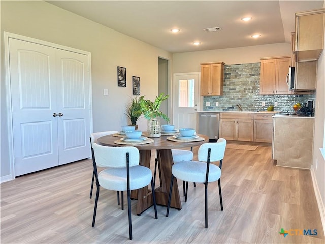 dining room featuring light wood-type flooring, visible vents, and recessed lighting