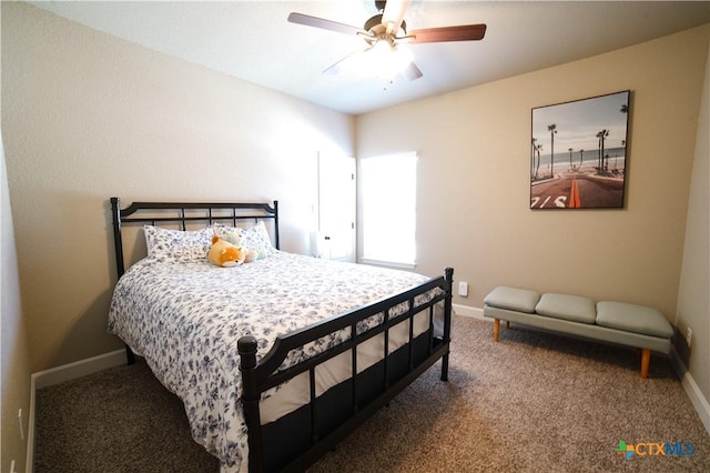 carpeted bedroom featuring ceiling fan and baseboards