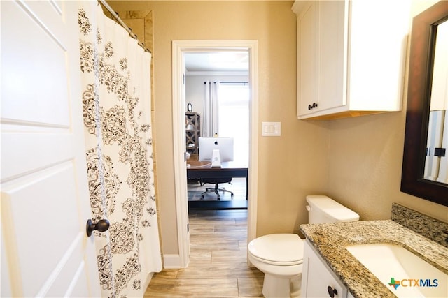 full bathroom with vanity, a shower with shower curtain, toilet, and wood finished floors