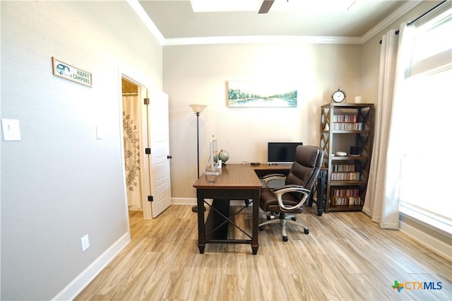 home office featuring crown molding, a ceiling fan, light wood-type flooring, and baseboards