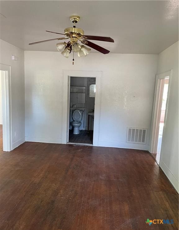 spare room with ceiling fan and dark wood-type flooring