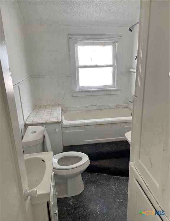 bathroom featuring vanity, a textured ceiling, and toilet