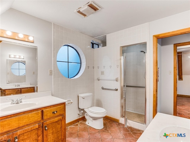 bathroom featuring vanity, a shower with door, a healthy amount of sunlight, and tile patterned floors