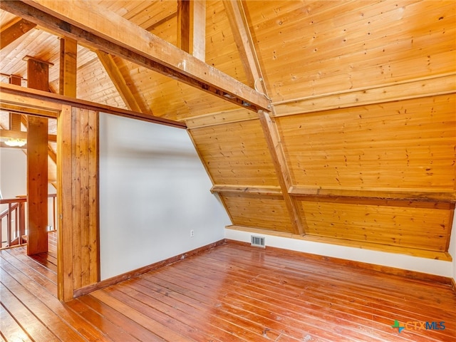 additional living space featuring vaulted ceiling with beams, hardwood / wood-style flooring, and wood ceiling