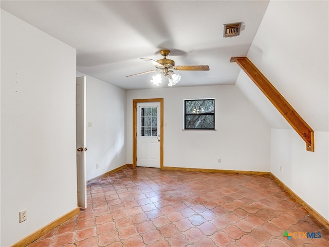 interior space with lofted ceiling and ceiling fan