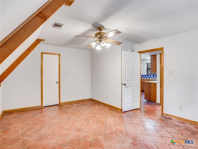 interior space with ceiling fan