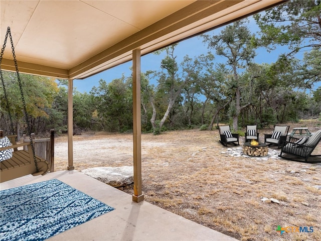 view of yard with a fire pit and a patio