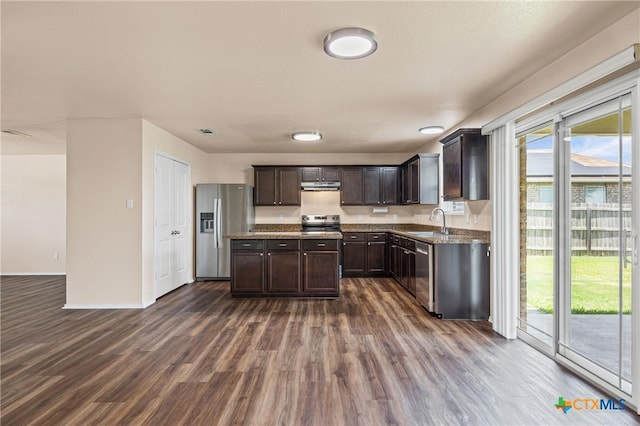2007 Jefferson Ct, Belton, TX 76513 - kitchen with appliances with stainless steel finishes, dark wood-style floors, dark brown cabinets, under cabinet range hood, and dark stone counters
