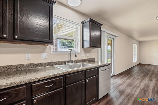 2007 Jefferson Ct, Belton, TX 76513 - kitchen featuring stainless steel dishwasher, dark countertops, dark wood-type flooring, and dark brown cabinetry