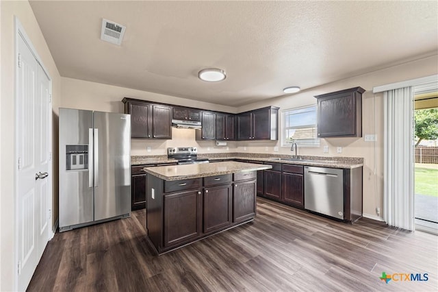 2007 Jefferson Ct, Belton, TX 76513 - kitchen featuring stainless steel appliances, dark wood-type flooring, dark brown cabinetry, and a center island
