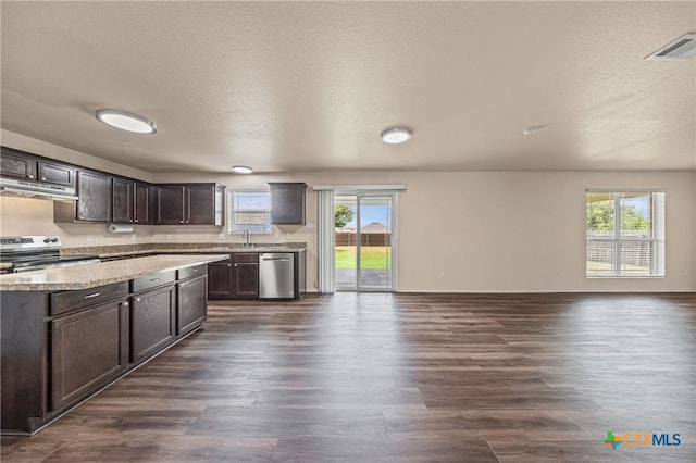 2007 Jefferson Ct, Belton, TX 76513 - kitchen featuring stainless steel appliances, under cabinet range hood, healthy amount of natural light, dark brown cabinets, and a textured ceiling