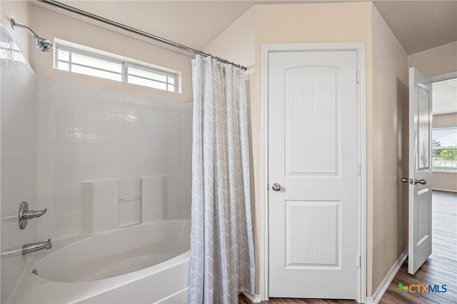 2007 Jefferson Ct, Belton, TX 76513 - bathroom featuring shower / bathtub combination with curtain and wood finished floors