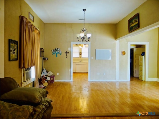 dining space featuring cooling unit, baseboards, wood finished floors, and a notable chandelier