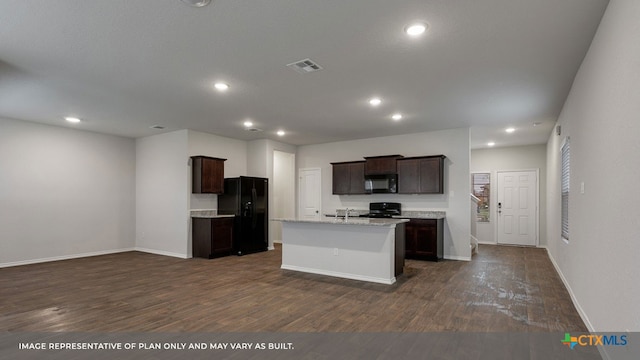 kitchen with an island with sink, sink, dark wood-type flooring, black appliances, and dark brown cabinets