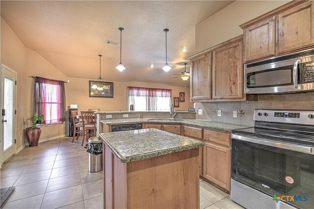 4813 Sapphire Dr, Killeen, TX 76542 - kitchen featuring stainless steel appliances, vaulted ceiling, light tile patterned floors, a center island, and a peninsula