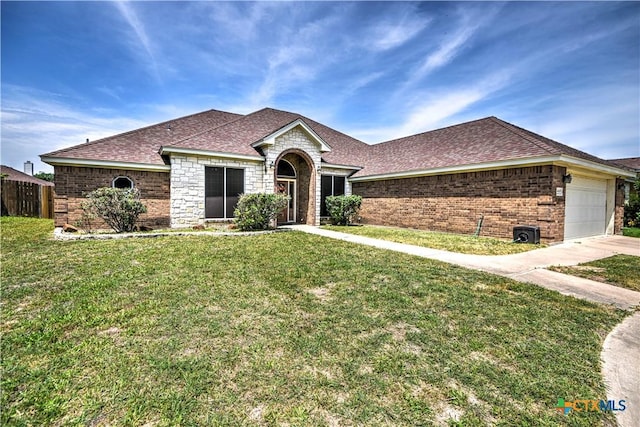 4813 Sapphire Dr, Killeen, TX 76542 - view of front of house with roof with shingles, an attached garage, brick siding, and stone siding