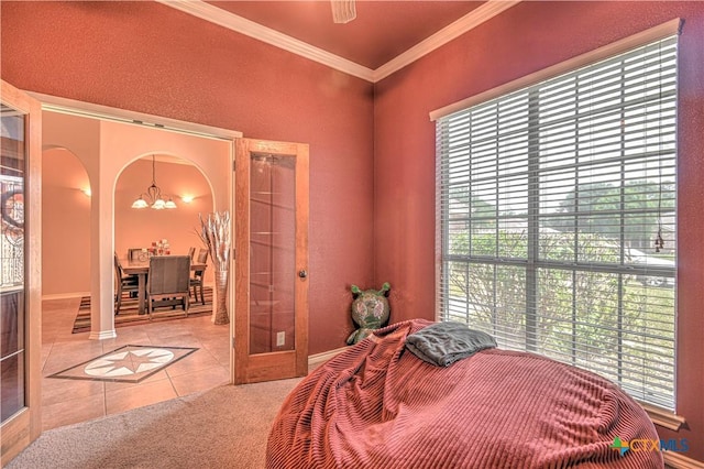 4813 Sapphire Dr, Killeen, TX 76542 - carpeted bedroom featuring tile patterned flooring, a chandelier, ornamental molding, multiple windows, and baseboards