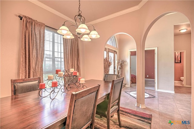 4813 Sapphire Dr, Killeen, TX 76542 - dining room featuring healthy amount of natural light, crown molding, arched walkways, tile patterned floors, and a chandelier