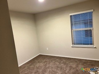 empty room with dark colored carpet