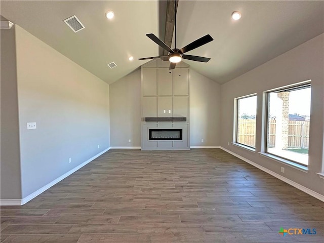 unfurnished living room with ceiling fan, a large fireplace, high vaulted ceiling, and hardwood / wood-style flooring