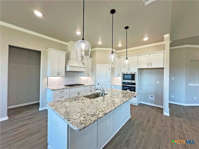 kitchen with decorative light fixtures, sink, white cabinetry, and stainless steel appliances