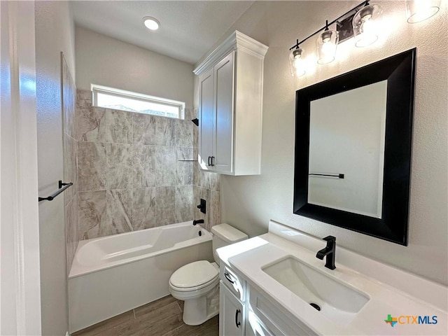 full bathroom with tiled shower / bath combo, toilet, and vanity