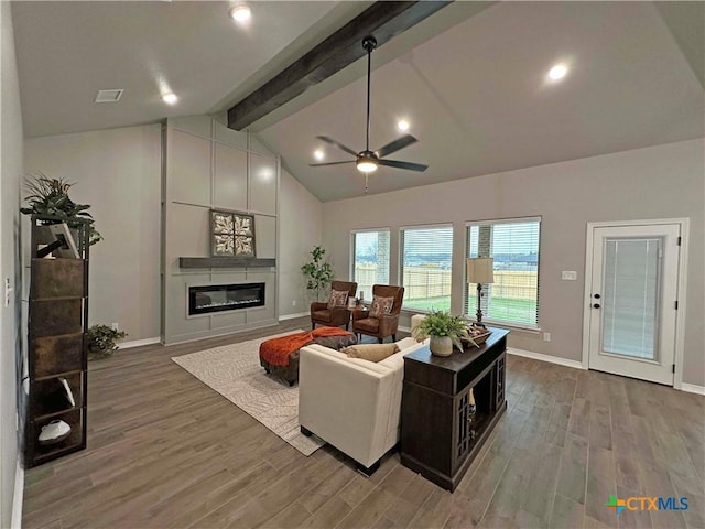 living room featuring a fireplace, ceiling fan, vaulted ceiling with beams, and hardwood / wood-style flooring