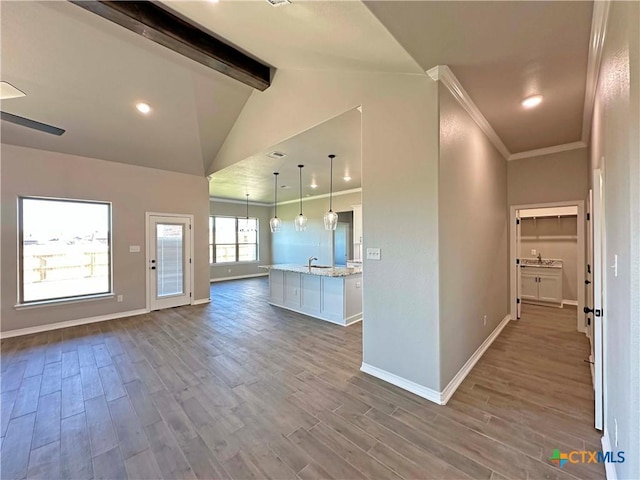 kitchen with hardwood / wood-style flooring, vaulted ceiling with beams, white cabinets, and hanging light fixtures