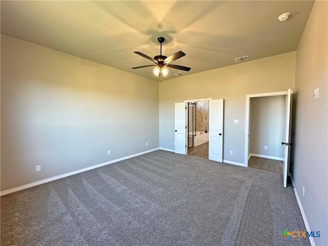 unfurnished bedroom with dark colored carpet and ceiling fan