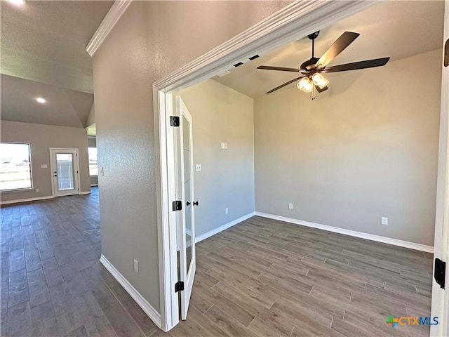 unfurnished room featuring ceiling fan, wood-type flooring, lofted ceiling, and ornamental molding