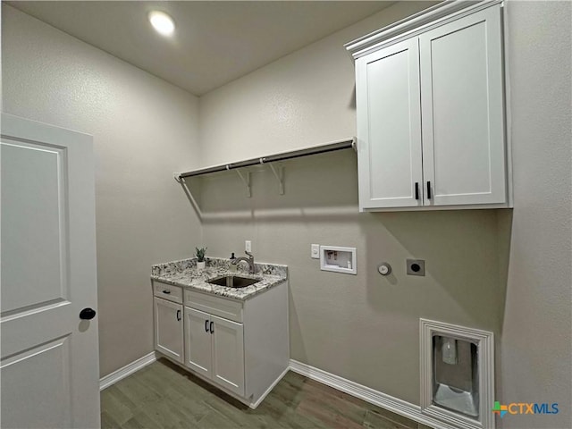 laundry area with cabinets, hookup for an electric dryer, dark wood-type flooring, and sink