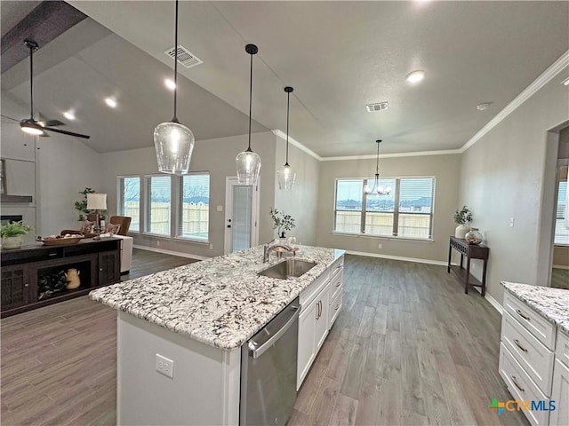 kitchen with a center island with sink, white cabinetry, sink, and dishwasher