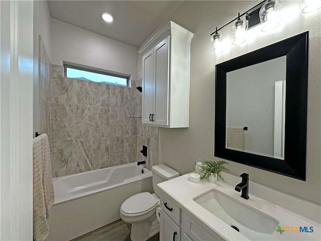 full bathroom featuring toilet, vanity, hardwood / wood-style floors, and tiled shower / bath combo